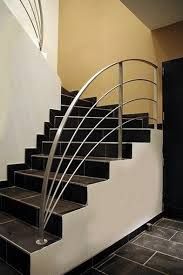 a set of black and white stairs leading up to a door