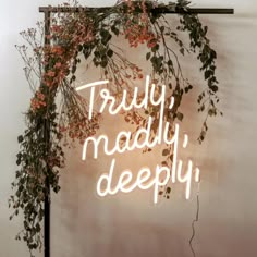 a neon sign that says truly, madly, deeply