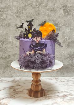 there is a purple cake with decorations on it