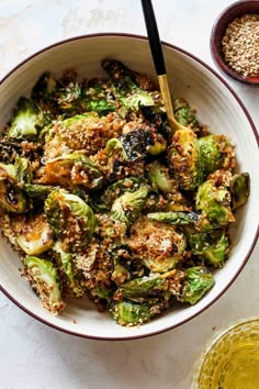 a bowl filled with cooked brussel sprouts and topped with sesame seeds