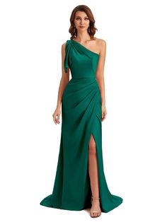 a woman wearing a green dress with one shoulder and side slit