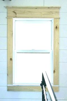 a pair of scissors sitting on top of a table next to a wooden window frame