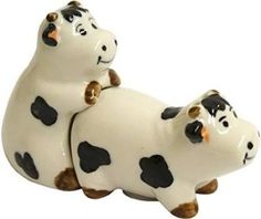 two ceramic cows sitting on top of each other