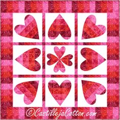 a pink and red checkered quilt with hearts in the shape of hearts on it