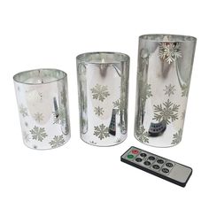 three glass vases and a remote control