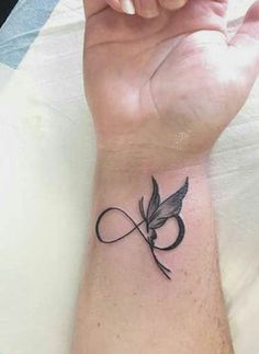 a person's arm with a tattoo on it and a butterfly in the middle