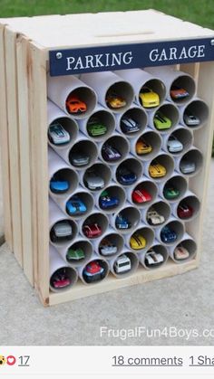 a wooden box filled with lots of different types of cars on top of cement ground