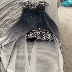 a black and white dress laying on top of a bed