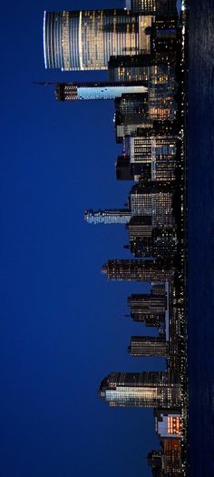 the skyline of new york city is lit up at night