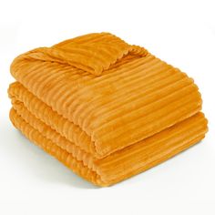 three orange towels stacked on top of each other in front of a white background,