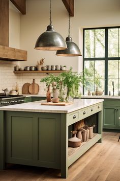 a kitchen with green cabinets and wooden floors