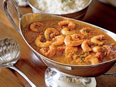 two silver bowls filled with shrimp and rice