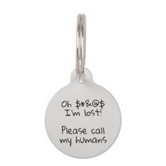 a white dog tag that says oh, i'm lost please call my humans