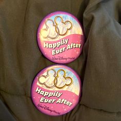 two buttons that say happily ever after and mickey mouse are on the back of a jacket