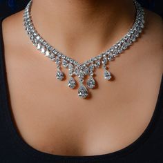 a woman wearing a diamond necklace on her neck