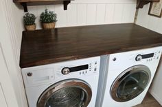 a washer and dryer sitting next to each other on top of a counter