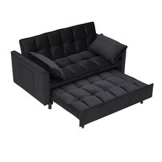 a black couch and ottoman with pillows on it