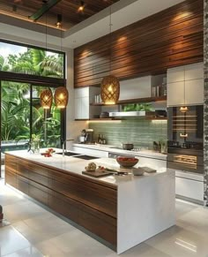 a modern kitchen with wood accents and white counter tops, along with large windows overlooking the jungle