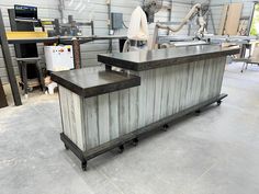 an industrial kitchen island in the middle of a garage