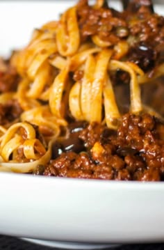 pasta with meat and sauce in a white bowl