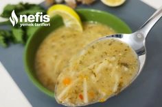 a spoon full of soup with broccoli and lemons next to it on a plate