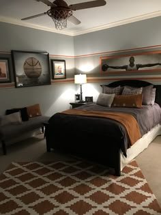 a bed room with a neatly made bed and a ceiling fan