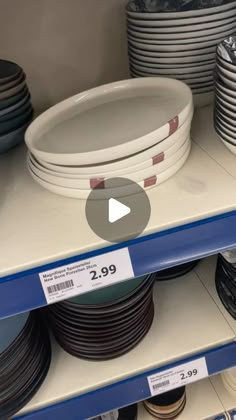 a shelf with plates and bowls on it for sale in a store or retail center