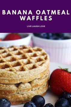 a stack of waffles sitting on top of a white plate next to blueberries and strawberries