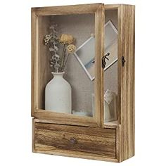 a wooden display case with flowers in it