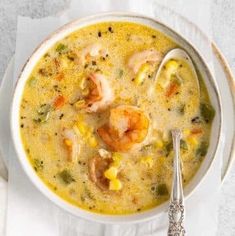 a white bowl filled with shrimp and corn soup