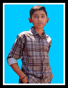 a young man standing in front of a blue background