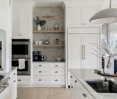 the kitchen is clean and ready for us to use it's white cabinetry