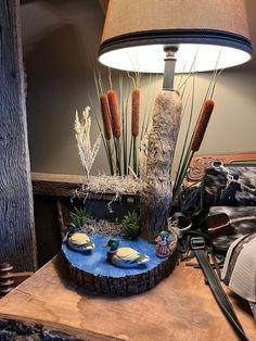 a lamp that is sitting on top of a wooden table next to a tree stump