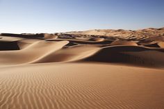 sand dunes in the desert with blue sky