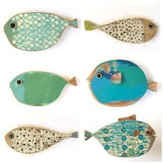 four different types of fish made out of wood