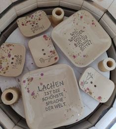 ceramic dishes with words written on them sitting on a table