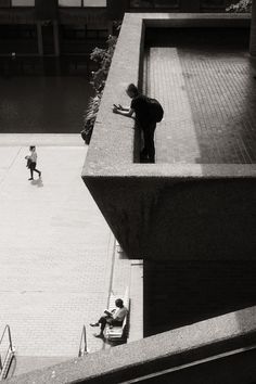 black and white photograph of people sitting on benches