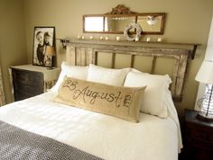 a bed with white linens and pillows in a bedroom next to two framed pictures