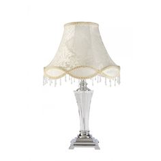 a table lamp with a white shade on it's base and beaded lampshade