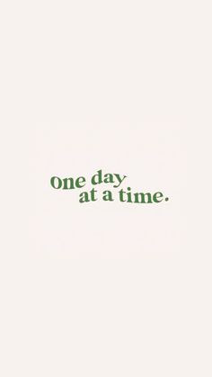 the words one day at a time are written in green ink on a white background