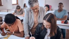 there are many people sitting at the desks