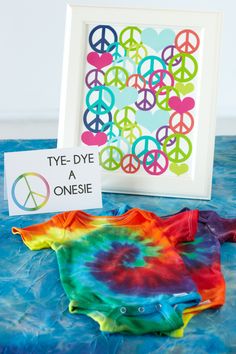 a tie - dyed shirt and peace sign are sitting on top of a blue table