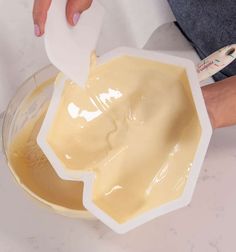 a person using a spoon to mix the liquid in a bowl