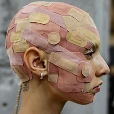 a woman's head with tape wrapped around it