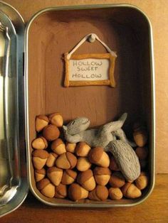 an open tin container filled with nuts on top of a wooden table