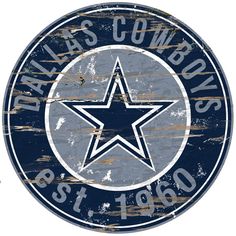 a wooden sign with the cowboys logo on it