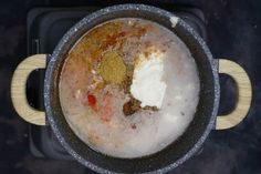 a pot filled with food sitting on top of a stove