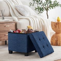 a blue ottoman sitting on top of a white rug