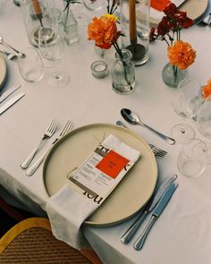 a table set with place settings and silverware