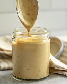 balsamic tahini dressing in a jar with a spoon